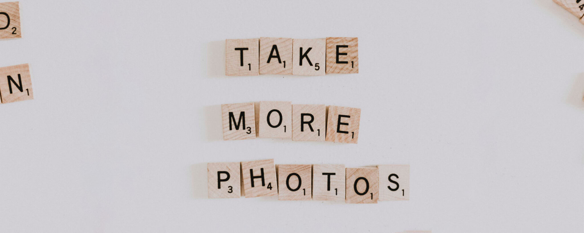 Scrabble Buchstaben zeigen den Spruch Take more Photos