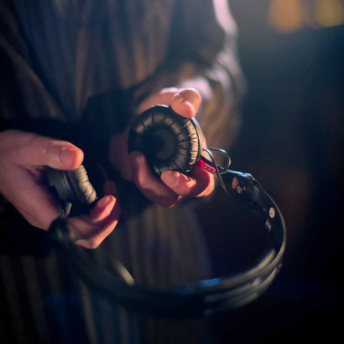 DJ Markus Rosenbaum holds his headphones in his hands.